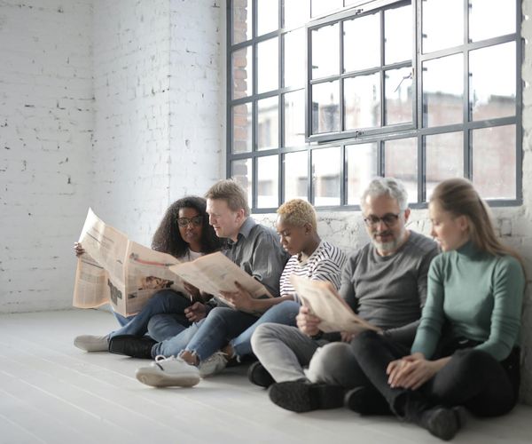 A group of diverse people in a bright, modern space.