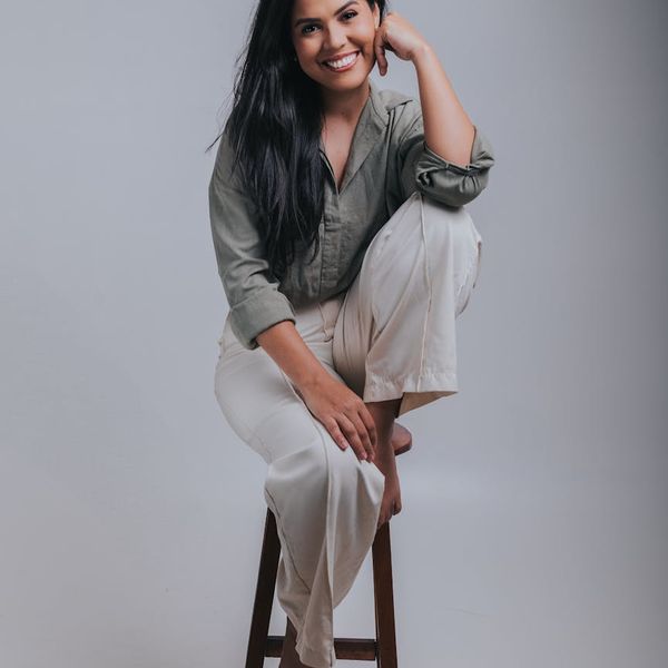 Portrait of a smiling confident woman in a studio setting.